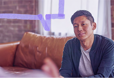 An adult man sitting on a couch